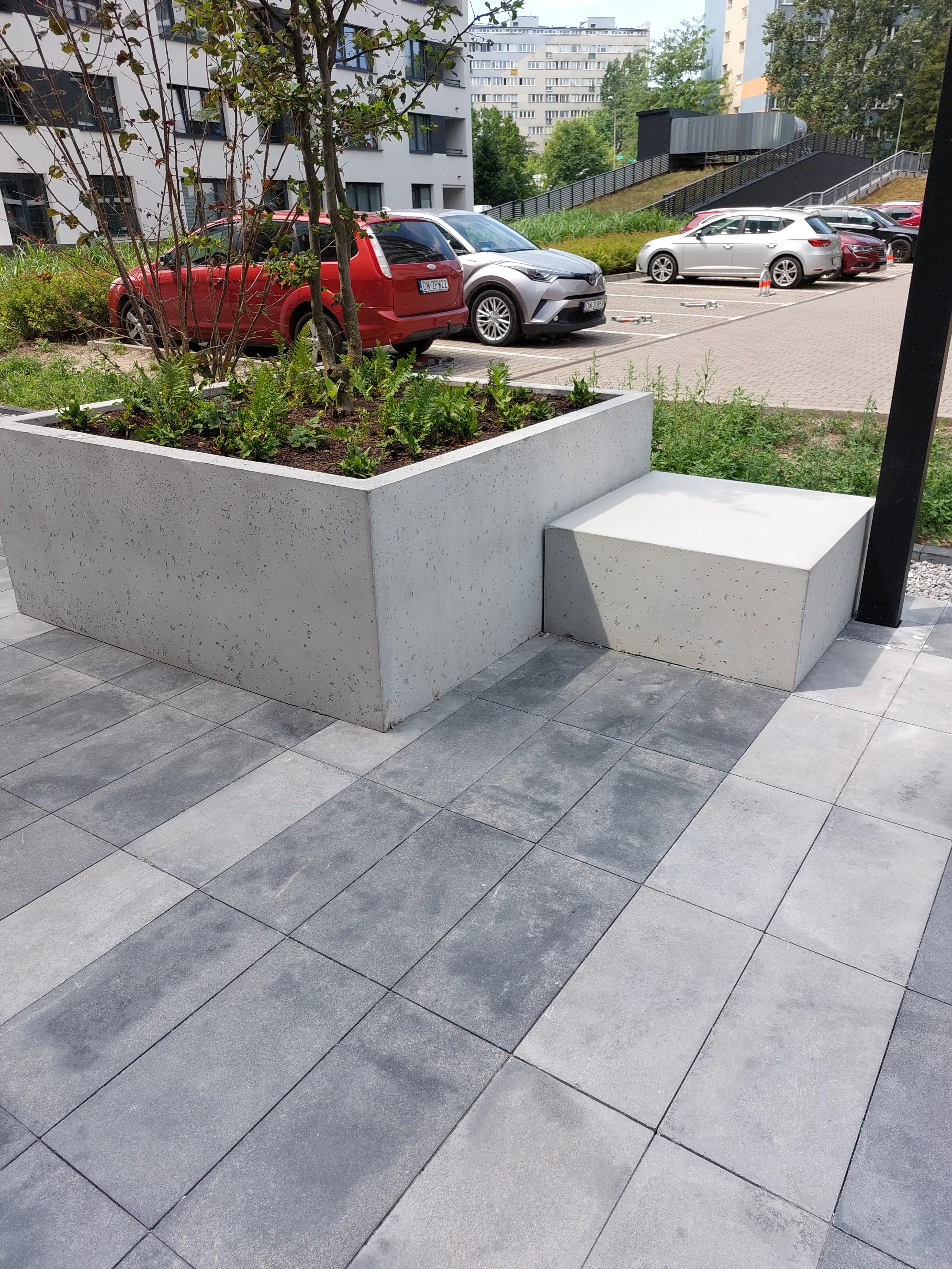 Outdoor Concrete Planters - Rectangle 50x120x50 cm in front of a parking lot Decormania.eu